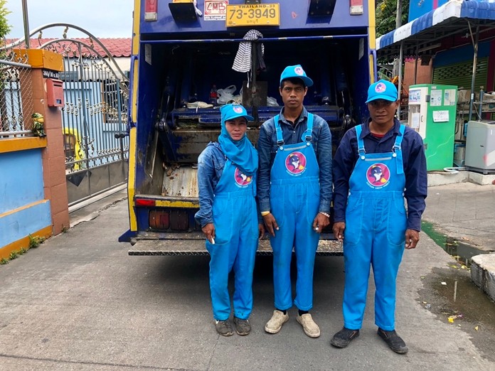 Trash collection staff pose in their new blue uniforms.