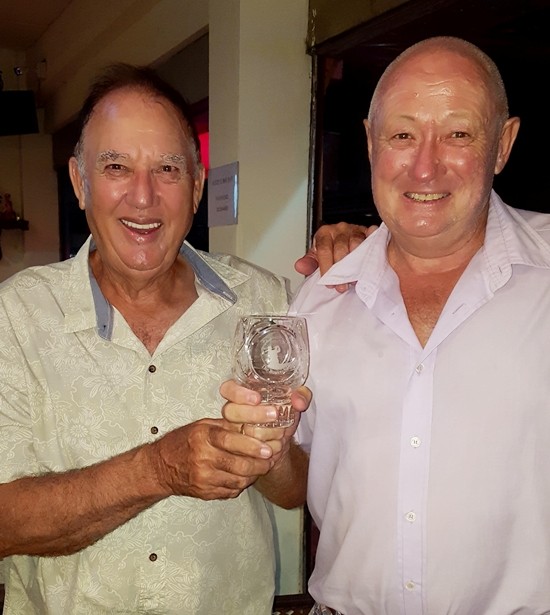 Jimmy Carr presents the golfer of the month trophy to Robby Watts.