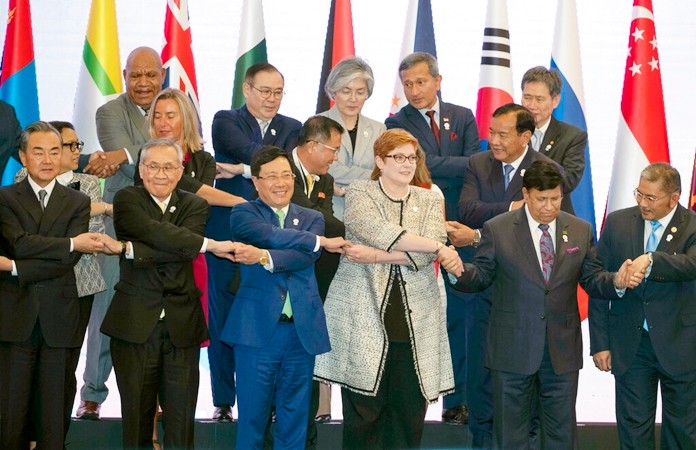Foreign ministers, front row from left, China's Wang Yi, Thailand's Don Pramudwinai, Vietnam's PhạmBinh Minh, Australia's Marise Payne, Bangladesh's Abdul Momen and Brunei Second Minister of Foreign Affairs and Trade Erywan Yusof join hands for a group photo during the Association of Southeast Asian Nations (ASEAN) Regional Forum in Bangkok, Thailand, Friday, Aug. 2, 2019. (AP Photo/Gemunu Amarasinghe)