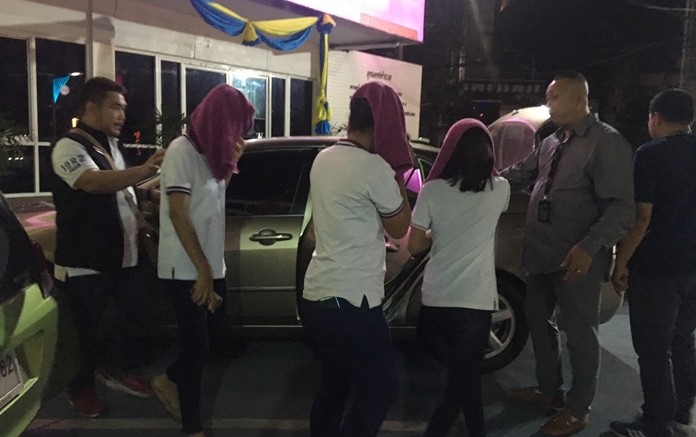 Police take into custody three underage girls from the Thong Dang Thai traditional massage parlor.