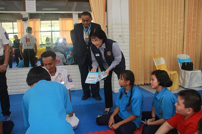 President Suphan Wiboonma distributes training manuals to the participants.