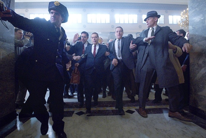 This image released by Netflix shows Al Pacino, center left, and Robert De Niro, center right, in a scene from “The Irishman.” (Netflix via AP)