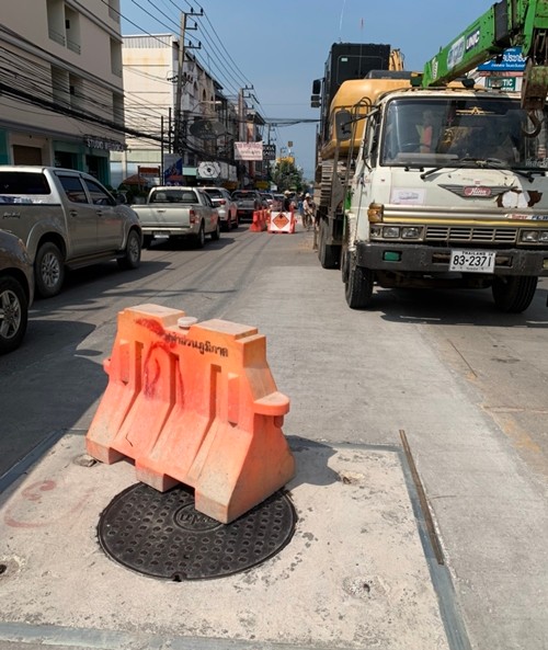 A road barrier is placed on the loose manhole cover to warn off drivers.