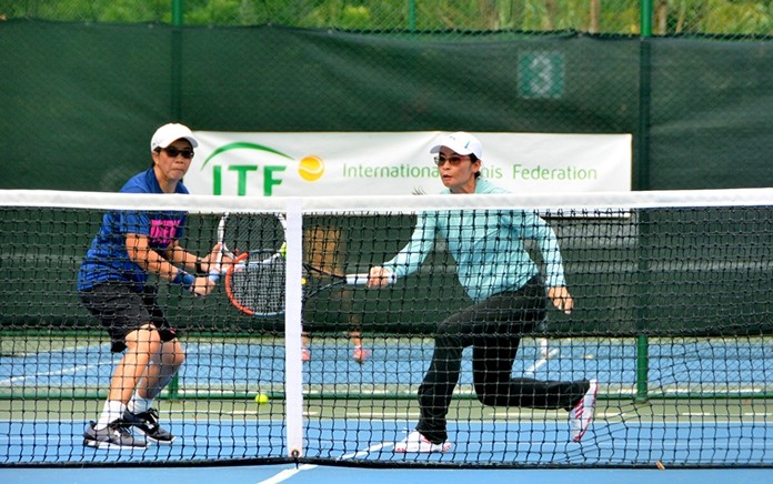 Women’s Doubles 35+ tennis players Arunya Wongkaew and Puttaruksa Jantamad return a volley during the ITF Seniors Championship held at Royal Cliff Royal Cliff Beach Resort’s Fitz Club.