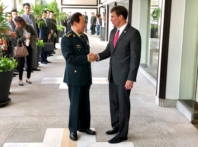 Chinese Defense Minister Wei Fenghe, left, greets U.S. Defense Secretary Mark Esper in Bangkok, Thailand, Monday, Nov. 18, 2019. The two held their first face-to-face talks Monday. (AP Photo/Robert Burns)