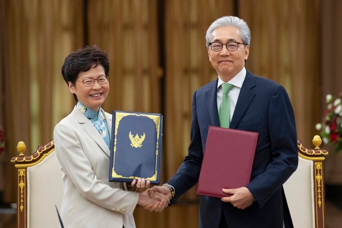 Hong Kong Chief Executive Carrie Lam, left, and Deputy Prime Minister Somkid Jatusripitak pose after signing memorandum of understanding on strengthening of economics relations at government house in Bangkok, Thailand, Friday, Nov. 29, 2019. (AP Photo/Sakchai Lalit)