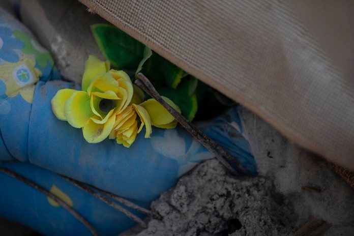 In this Wednesday, Nov. 27, 2019 photo, a plastic flower among rubbles of a collapsed building damage building in Thumane, western Albania following a deadly earthquake.(AP Photo/Petros Giannakouris)