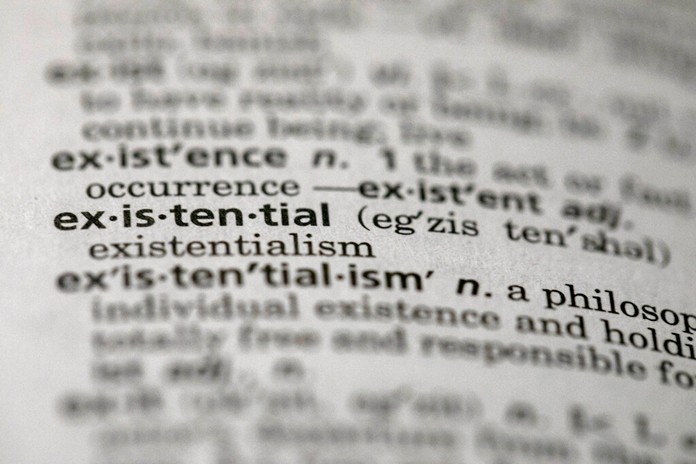 This Sunday, Dec. 1, 2019, photo shows the word "existential" in a dictionary in the Brooklyn borough of New York. Dictionary.com picked “existential” as the word of the year. (AP Photo/Jenny Kane)