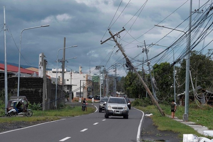 Vehicles pass by toppled electrical poles as Typhoon Kammuri slammed Legazpi city, Albay province, southeast of Manila, Philippines on Tuesday, Dec. 3, 2019. (AP Photo)