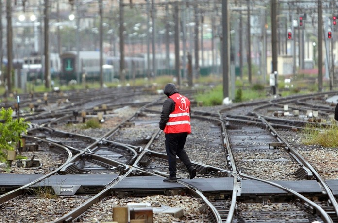 In this May 14, 2018 file photo, a striking rail worker walks on the tracks of the Saint-Charles train station, in Marseille, southern France. (AP Photo/Claude Paris, File)