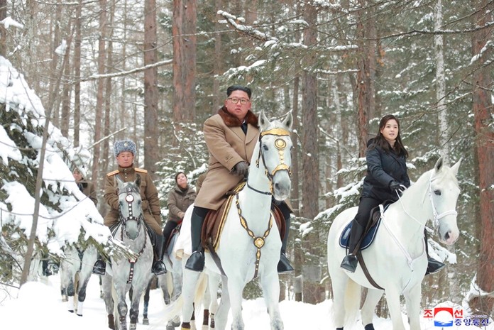 This undated photo provided on Wednesday, Dec. 4, 2019, by the North Korean government shows North Korean leader Kim Jong Un, center, with his wife Ri Sol Ju, right, riding on white horse during his visit to Mount Paektu, North Korea. (Korean Central News Agency/Korea News Service via AP)