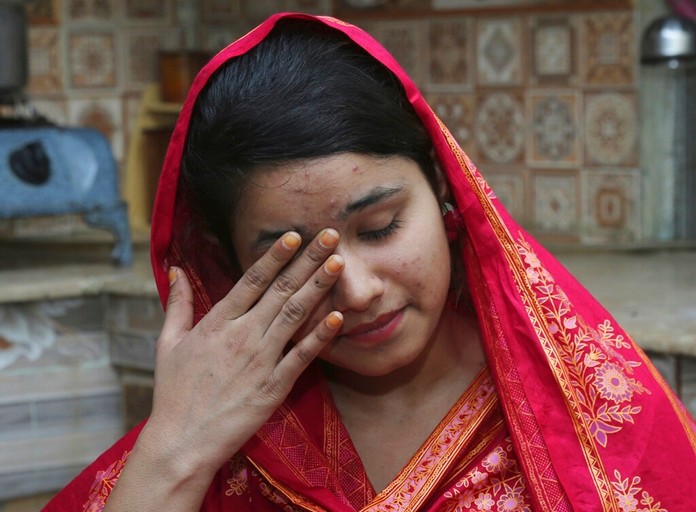 In this April 14, 2019 file photo, Pakistani Christian Mahek Liaqat, who married a Chinese national, cries as she narrates her ordeal, in Gujranwala, Pakistan. (AP Photo/K.M. Chaudary, File)
