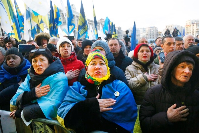 Activists sing the national anthem during a rally in central Kyiv, Ukraine, Sunday, Dec. 8, 2019. ( AP Photo/Efrem Lukatsky)