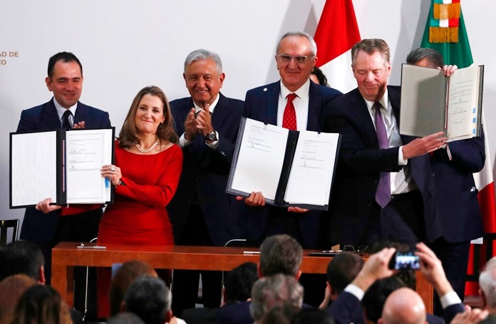 Mexico's Treasury Secretary Arturo Herrera, left, Deputy Prime Minister of Canada Chrystia Freeland, second left, Mexico's President Andres Manuel Lopez Obrador, center, Mexico's top trade negotiator Jesus Seade, second right, and U.S. Trade Representative Robert Lighthizer, hold the documents after signing an update to the North American Free Trade Agreement, at the national palace in Mexico City, Tuesday, Dec. 10. 2019. (AP Photo/Marco Ugarte)