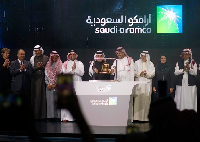 Saudi Arabia's state-owned oil company Saudi Armco and stock market officials celebrate during the official ceremony marking the debut of Aramco's initial public offering (IPO) on the Riyadh's stock market, in Riyadh, Saudi Arabia, Wednesday, Dec. 11, 2019. (AP Photo/Amr Nabil)