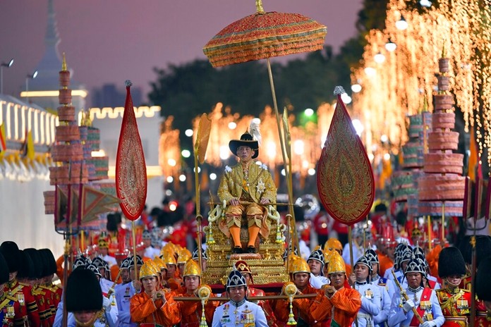 HM King Maha Vajiralongkorn is transported on the royal palanquin during the Royal Procession outside the Grand Palace in Bangkok, Thailand, Thursday, Dec. 12, 2019. (AP Photo/Suganya Samnangjam)