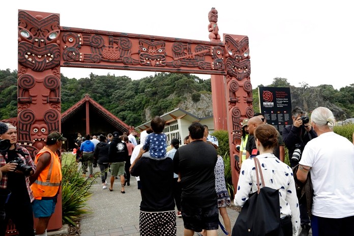 Families of victims of the White Island eruption walkminto a nearby marae following a blessing at sea ahead of the recovery operation off the coast of Whakatane New Zealand, Friday, Dec. 13, 2019. (AP Photo/Mark Baker)