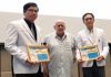 MC Les Edmonds (center) presents Dr. Tanakorn (on his right) and Dr. Natchai (on his left) with the PCEC's Certificate of Appreciation for their enlightening talk about the seriousness of a stroke, its treatment, and rehabilitation.