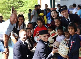 HHNFT Director Radchada Chomjinda and children present bags and hats the children made for their Lufthansa guests to take home as souvenirs.