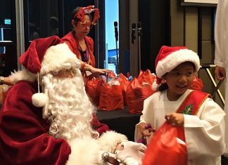 A happy smile as this young lady receives her Christmas present from Santa.
