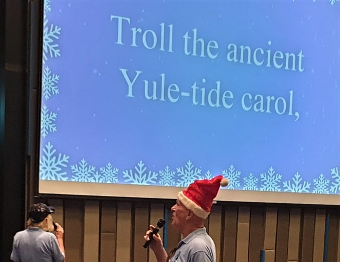 A little prompting helps. PCEC members and guests were able to follow along as members from Pattaya Players led them in singing traditional Christmas Carols.