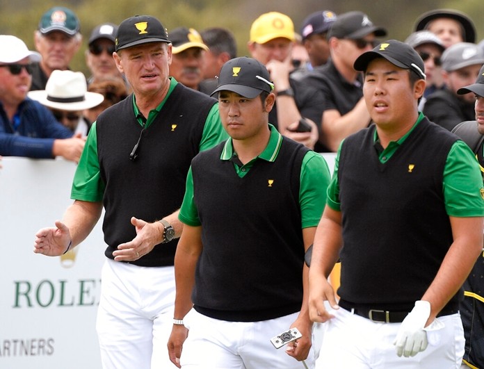 International team captain Ernie Els, left, Hideki Matsuyama of Japan and Byeong Hun An of South Korea, right, walk off the 5th tee in their foursomes match during the President's Cup golf tournament at Royal Melbourne Golf Club in Melbourne, Friday, Dec. 13, 2019. (AP Photo/Andy Brownbill)
