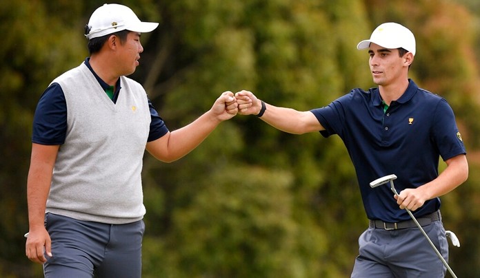 International team player Byeong Hun An of South Korea, left, and playing partner Joaquin Niemann of Chile celebrate on the 12th green in their foursome match. (AP Photo/Andy Brownbill)