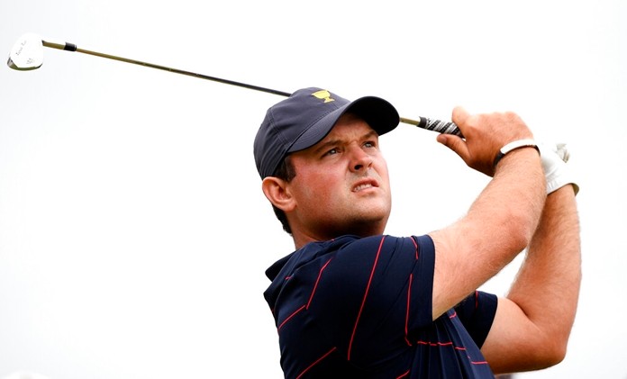 U.S. team player Patrick Reed hits on the 14th hole in their fourball match during the President's Cup. (AP Photo/Andy Brownbill)