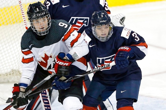 In this Dec. 5, 2017, file photo, United States' Cayla Barnes, right, defends against Canada's Jennifer Wakefield during the third period of a women's hockey game in Winnipeg, Manitoba, Canada. The United States renewed their fierce hockey rivalry against Canada on Saturday, Dec. 14, in Hartford, Conn., with players hoping the first in a series of five games will help kindle the public's interest in their sport and their fight for better professional opportunities. (John Woods/The Canadian Press via AP, File)