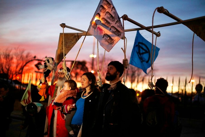Activist protest outside of the COP25 climate talks congress in Madrid, Spain, Saturday, Dec. 14, 2019. (AP Photo/Manu Fernandez)