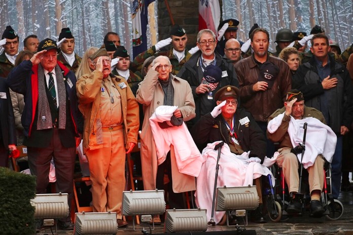 U.S. Battle of the Bulge veterans, front row, listen to the U.S. national anthem during a ceremony to commemorate the 75th anniversary of the Battle of the Bulge at the Mardasson Memorial in Bastogne, Belgium on Monday, Dec. 16, 2019. (AP Photo/Francisco Seco)