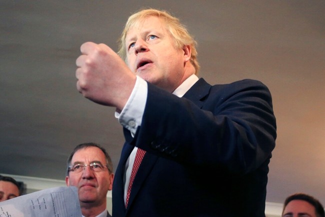 Britain's Prime Minister Boris Johnson, gestures as he speaks to supporters on a visit to meet newly elected Conservative party MP for Sedgefield, Paul Howell, at Sedgefield Cricket Club in County Durham, north east England, Saturday Dec. 14, 2019, following his Conservative party's general election victory. (Lindsey Parnaby/Pool via AP)