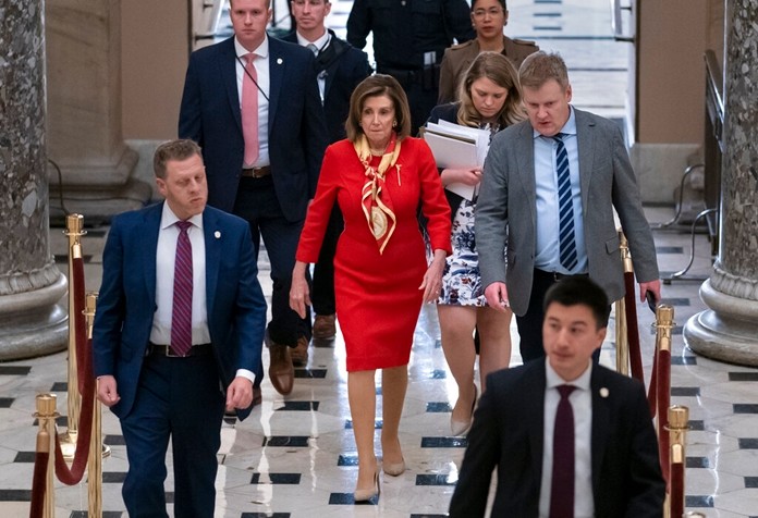 House Speaker Nancy Pelosi, D-Calif., walks from the chamber through Statuary Hall a day after the Democratic-controlled House of Representatives voted to impeach President Donald Trump on charges of abuse of power and obstruction of Congress, at the Capitol in Washington, Wednesday, Dec. 18, 2019. (AP Photo/J. Scott Applewhite)