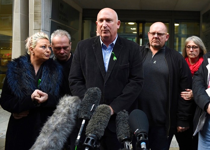 The family of Harry Dunn, from left, mother Charlotte Charles, stepfather Bruce Charles, family spokesman Radd Seiger, father Tim Dunn and stepmother Tracey Dunn speak to the media outside the Ministry Of Justice in London, Friday, Dec. 20, 2019. (David Mirzoeff/PA via AP)