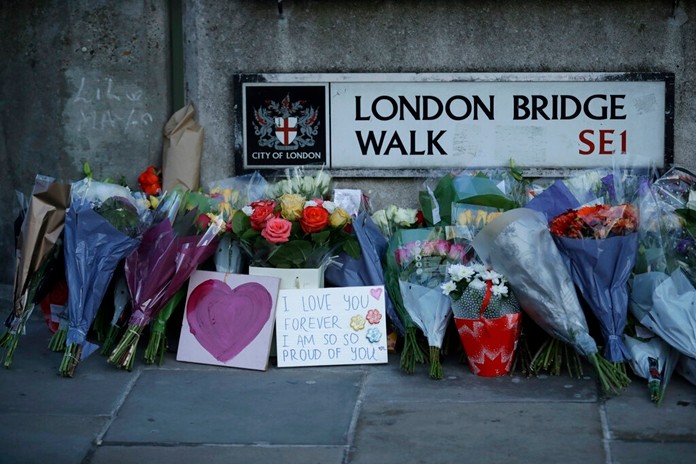 In this Monday, Dec. 2, 2019 file photo, tributes are placed by the southern end of London Bridge, three days after a man stabbed two people to death and injured three others before being shot dead by police, in London.(AP Photo/Matt Dunham, file)