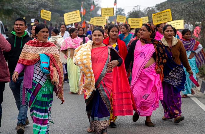 Activists of India's ruling Bharatiya Janata Party (BJP) participate in a procession urging for peace after violence broke out in several parts of the country during protests against the Citizenship Amendment Act, in Nalbari, India, Friday, Dec. 20, 2019. (AP Photo/AnupamNath)