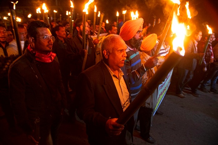 Indian protestors march in a torch light procession against the Citizenship Amendment act in Gauhati, India, Friday, Dec. 20, 2019. (AP Photo/AnupamNath)