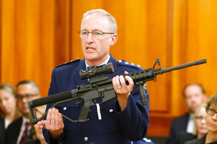 In this April 2, 2019, file photo, police acting superintendent Mike McIlraith shows New Zealand lawmakers an AR-15 style rifle similar to one of the weapons a gunman used to slaughter 51 worshippers at two Christchurch mosques, in Wellington, New Zealand. (AP Photo/Nick Perry, File)