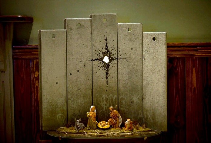 A new artwork dubbed "Scar of Bethlehem" by the artist Banksy is displayed in The Walled Off Hotel, in the West Bank city of Bethlehem, Sunday, Dec. 22, 2019. (AP Photo/Majdi Mohammed)