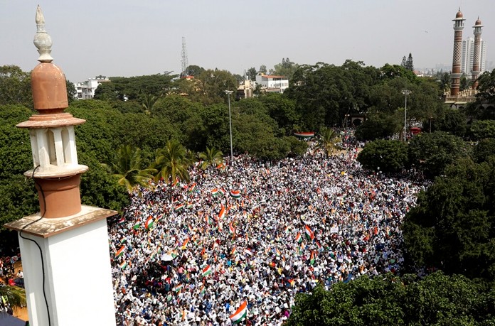 Indians hold national flags and placards during a protest organized by several Muslim organizations against a new citizenship law that opponents say threatens India's secular identity in Bangalore, India, Monday, Dec. 23, 2019. (AP Photo/AijazRahi)