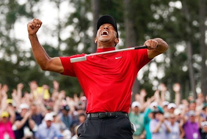 In this April 14, 2019 file photo, Tiger Woods reacts as he wins the Masters golf tournament in Augusta, Ga. Woods' victory at the Masters might not have been the most important sports story of 2019. It was certainly one of the most uplifting. Voters chose Woods' dramatic comeback at Augusta National as The Associated Press sports story of the year.  (AP Photo/David J. Phillip, File)