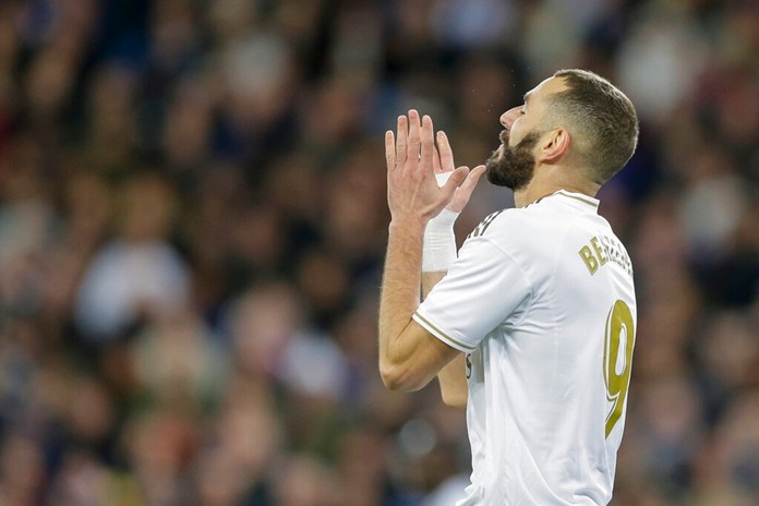 Real Madrid's Karim Benzema reacts after failing a scoring chance during a Spanish La Liga soccer match between Real Madrid and Athletic Bilbao at the Santiago Bernabeu stadium in Madrid, Spain, Sunday Dec. 22, 2019. (AP Photo/Paul White)