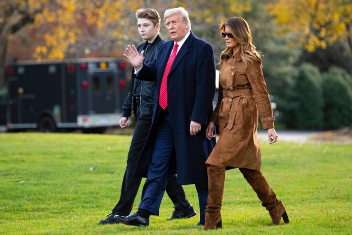 In this Nov. 26, 2019, file photo, President Donald, first lady Melania Trump, and Barron Trump, walk to board Marine One on the South Lawn of the White House, in Washington. (AP Photo/ Evan Vucci, File)