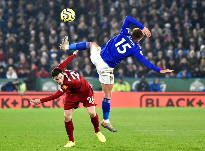 Liverpool's Andrew Robertson, left, and Leicester's Harvey Barnes challenge for the ball during the English Premier League soccer match between Leicester City and Liverpool at the King Power Stadium in Leicester, England, Thursday, Dec. 26, 2019. (AP Photo/Rui Vieira)