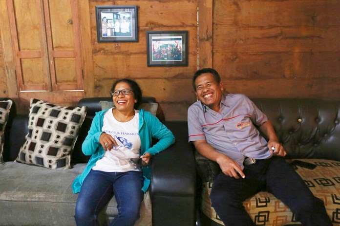 Ni LuhErniati, left, laughs with Ali Fauzi during her visit to Fauzi's house in Tenggulun, East Java, Indonesia, on Saturday, April 27, 2019. (AP Photo/TatanSyuflana)