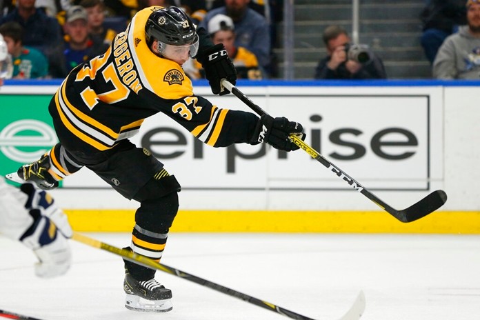 Boston Bruins forward Patrice Bergeron (37) shoots during the second period of an NHL hockey game against the Buffalo Sabres, Friday, Dec. 27, 2019, in Buffalo, N.Y. (AP Photo/Jeffrey T. Barnes)