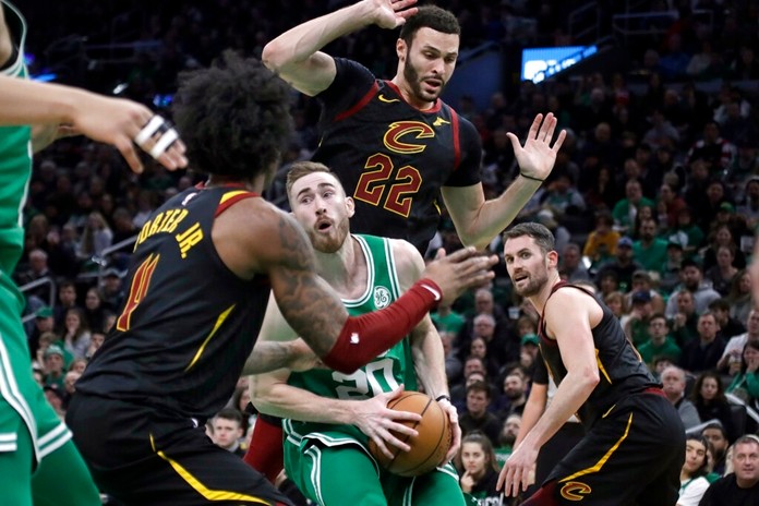 Boston Celtics forward Gordon Hayward looks for room to maneuver with the ball against Cleveland Cavaliers guard Kevin Porter Jr. (4), forward Larry Nance Jr. (22) and forward Kevin Love (0) in the second half of an NBA basketball game, Friday, Dec. 27, 2019, in Boston. (AP Photo/Elise Amendola)