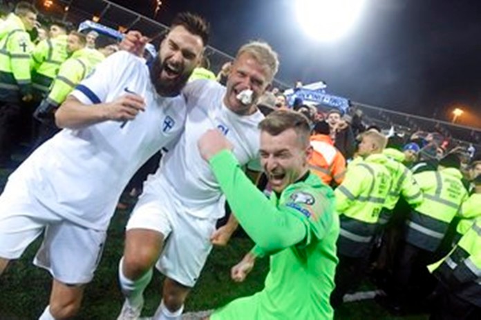 Finnish captain Tim Sparv, left, celebrates with Paulus Arajuuri, center, and goalkeeper Lukas Hradecky after their victory in the Euro 2020 Group J qualifying soccer. Stock up on beer. The Finns are coming. That's the message from Finland goalkeeper Lukas Hradecky as his country prepares to play at soccer's European Championship for the first time in 2020. (Markku Ulander/Lehtikuva via AP)