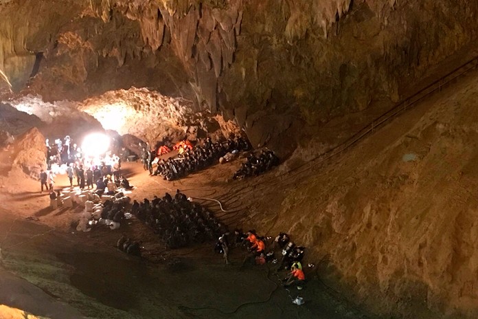 In this June 26, 2018, file photo, emergency rescue teams gather in the staging area as they continue the search for a young soccer team and their coach believed to be missing in a large cave in Mae Sai, Chiang Rai province, northern Thailand. (AP Photo/TassaneeVejpongsa, File)