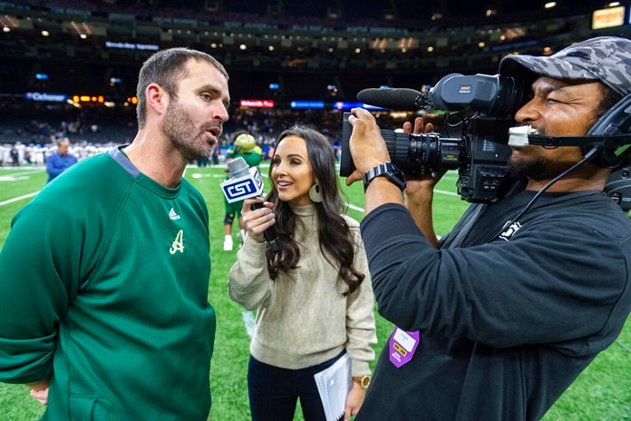 In this Dec. 14, 2019 photo Acadiana head coach Matt McCullough, left, speaks with Carley McCord, center, following a win over the Destrehan in the State Division 5A Championship football game in Lafayette, La. Carley McCord died in the crash in Louisiana on Saturday, Dec. 28, on the way to a college football playoff game in Atlanta. (Scott Clause/The Daily Advertiser via AP)